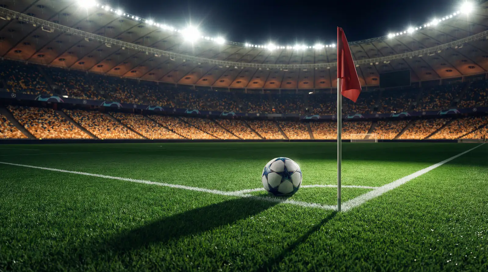 Apuestas Champions League: balón oficial junto al banderín de córner en un estadio nocturno